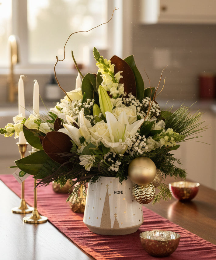 Bouquet of flowers with greenery and gold ornaments on a kitchen table